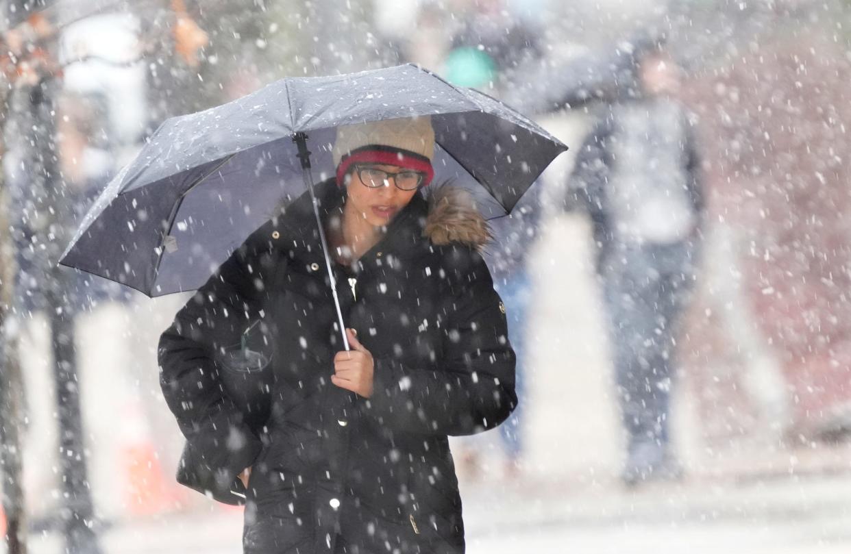 A pedestrian makes their way through the cold rain and snow along North Milwaukee Street in Milwaukee on Thursday, April 4, 2024. Milwaukee and southern Wisconsin are entering the third consecutive day of widespread rain and snowfall. Dry weather is expected over the weekend, with partly sunny skies Friday and a sunny Saturday.