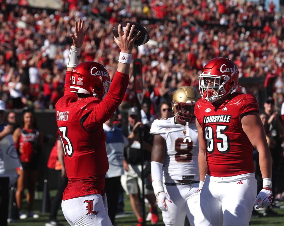 Louisville’s Jack Plummer celebrates with Mason Reiger after a touchdown against Boston College on Saturday afternoon at L&N Stadium.