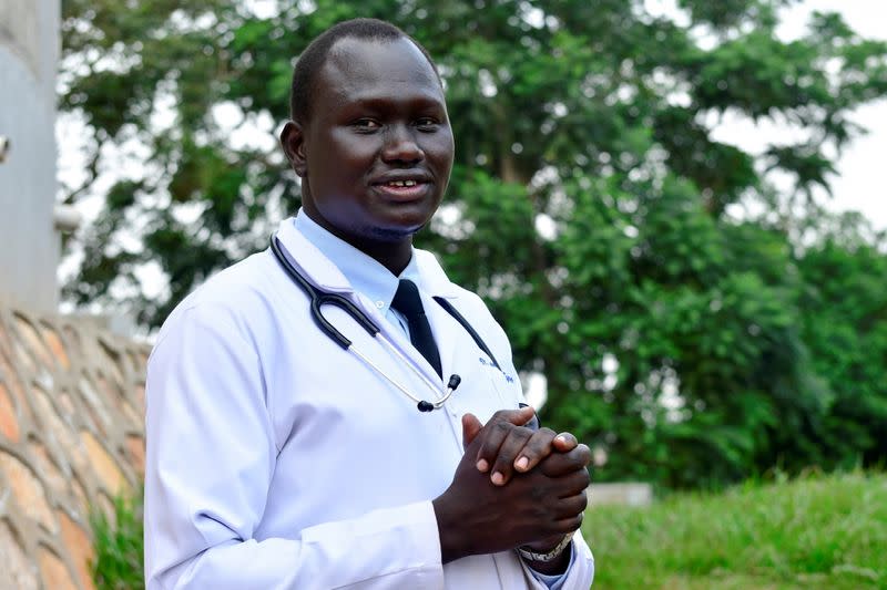 Trainee doctor who fled from South Sudan to Uganda poses for a photo at Mulago National Specialised Hospital in Kampala