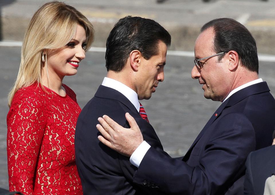 French President Francois Hollande greets Mexico's President Enrique Pena Nieto and Mexico's First Lady Angelica Rivera at the start of the traditional Bastille Day military parade in Paris