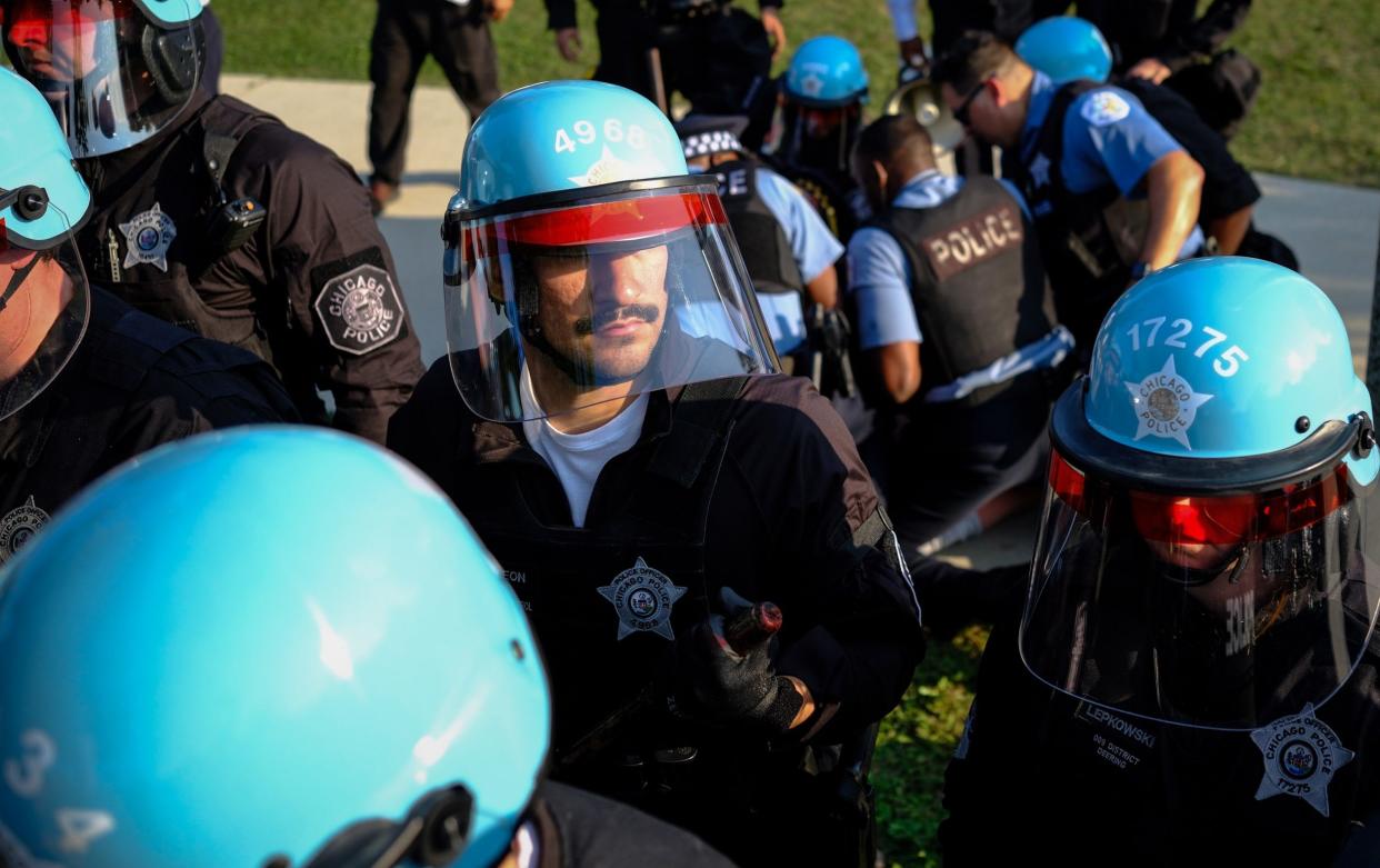 Chicago police watch as protesters gather during the Democratic National Convention