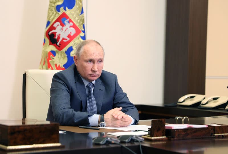 Russian President Vladimir Putin chairs a a video conference meeting outside Moscow