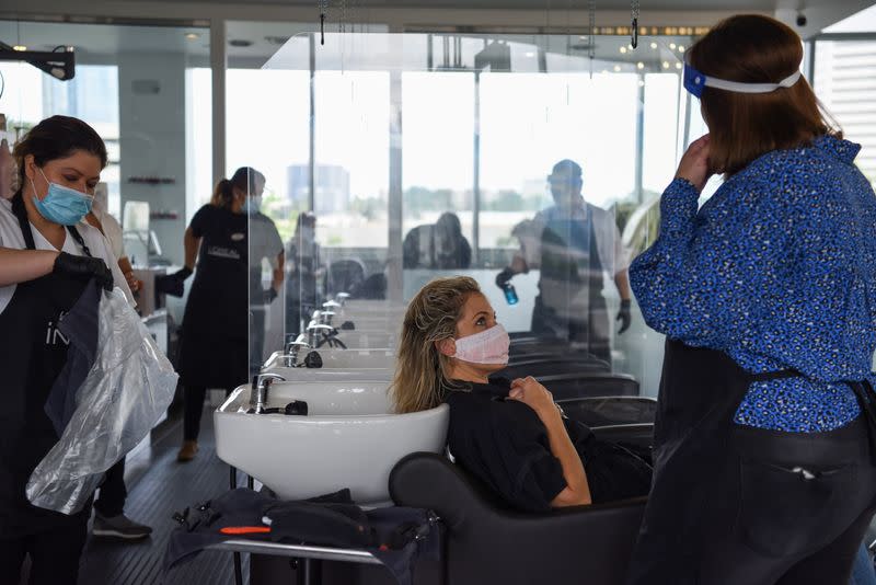 A woman prepares to have her hair washed as social distancing guidelines to curb the spread of the coronavirus disease (COVID-19) are relaxed, at Bella Rinova, in Houston