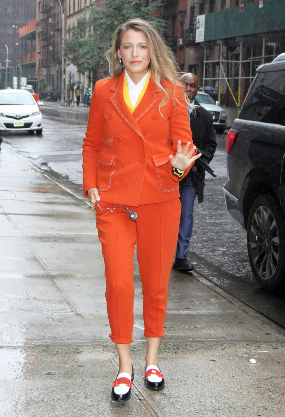 Lively then stepped out in this bright orange suit by Bottega Veneta when she made an appearance at Twitter.&nbsp;