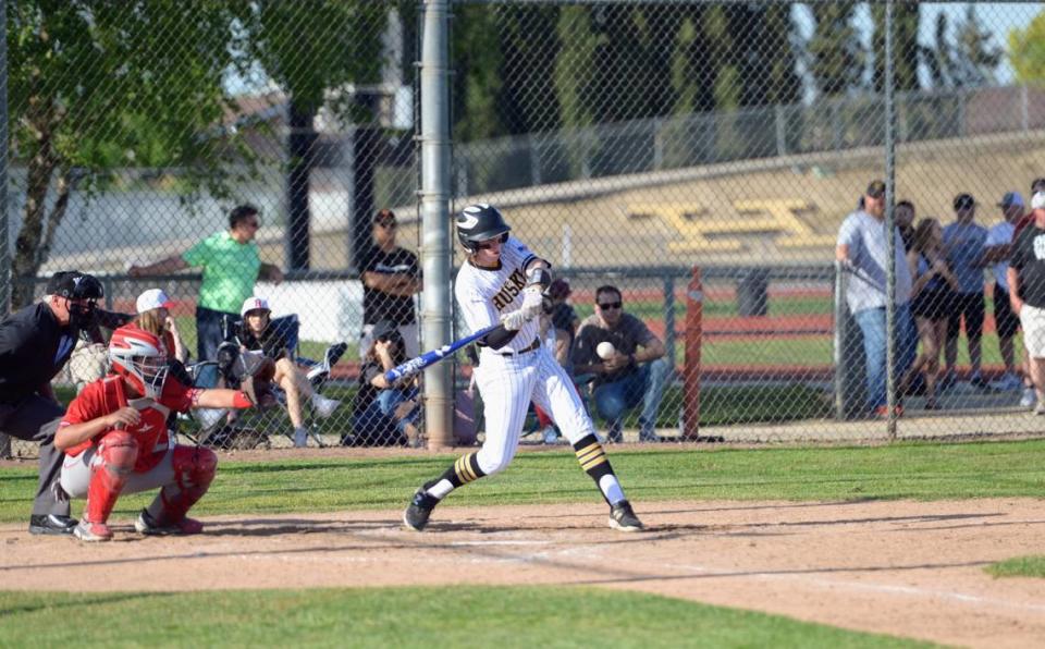 Hughson’s Caleb Wilson makes contact with a pitch during a Trans Valley League game against Ripon at Ripon High School in Ripon, Calif. on April 18, 2024.