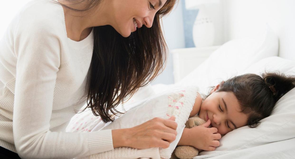 Tucking child in sleep. (Getty Images)