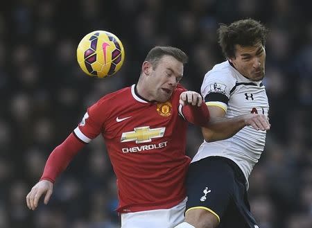 Benjamin Stambouli (R) challenges Wayne Rooney during their English Premier League soccer match at White Hart Lane in London December 28, 2014. REUTERS/Dylan Martinez