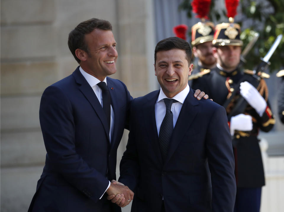 FILE In this file photo taken on Monday, June 17, 2019, French President Emmanuel Macron, right, greets Ukrainian President Volodymyr Zelenskiy before a meeting at the Elysee Palace, in Paris, France. Ukraine's president sits down Monday, Dec. 9, 2019 for peace talks in Paris with Russian President Vladimir Putin in their first face-to-face meeting, and the stakes could not be higher. More than five years of fighting in eastern Ukraine between government troops and Moscow-backed separatists has killed more than 14,000 people, and a cease-fire has remained elusive. (AP Photo/Christophe Ena, File)