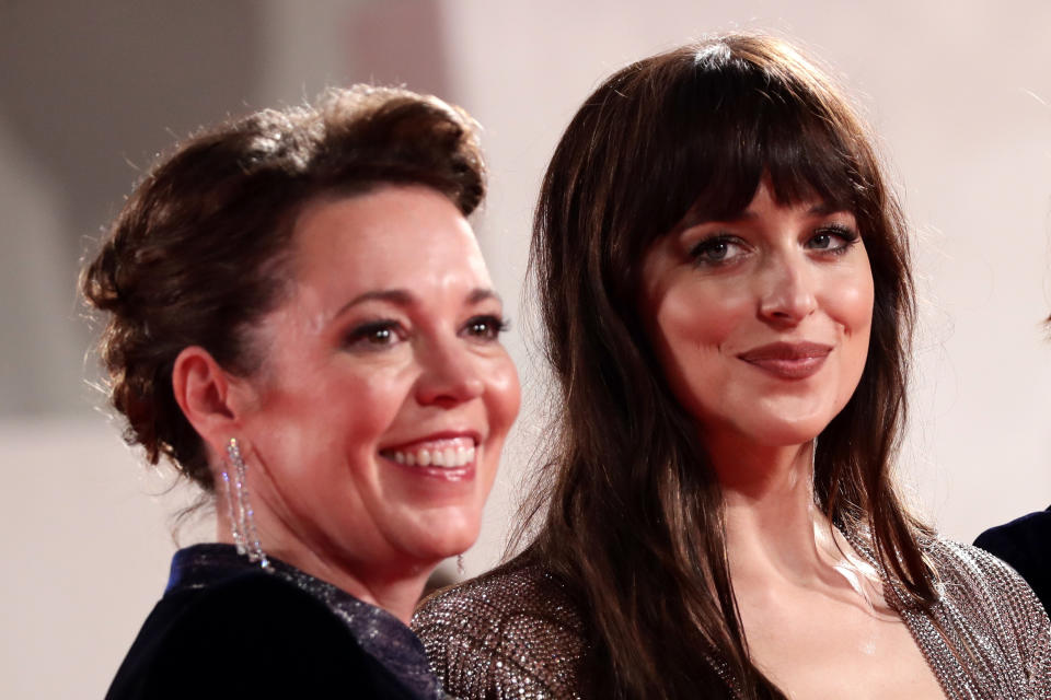 Olivia grinning next to Dakota Johnson smiling