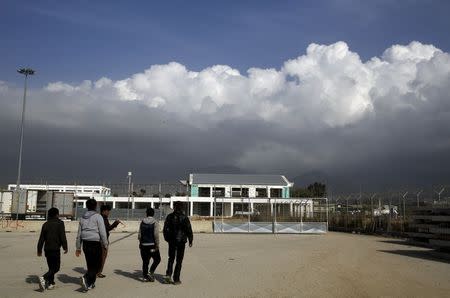 Afghan immigrants walk through the ferry terminal at the western Greek town of Patras April 28, 2015. REUTERS/Yannis Behrakis