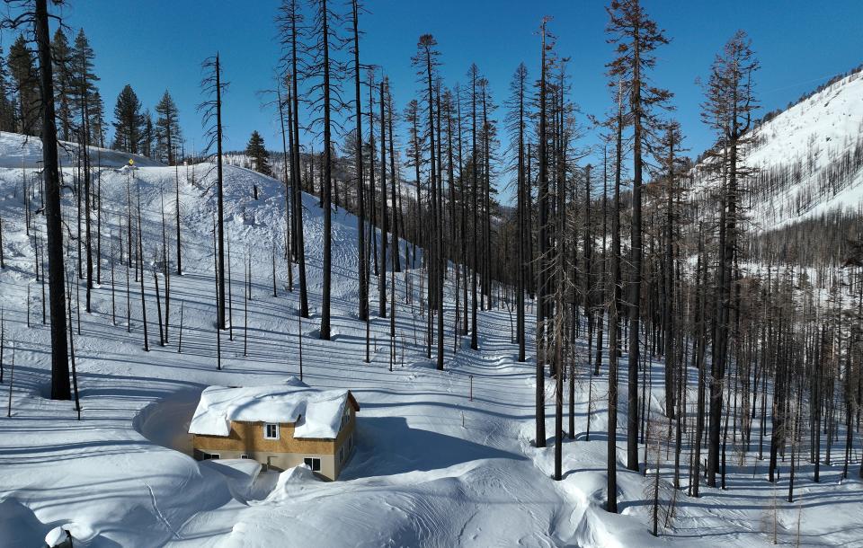 A home is covered in snow on March 3 in Twin Bridges, Calif.