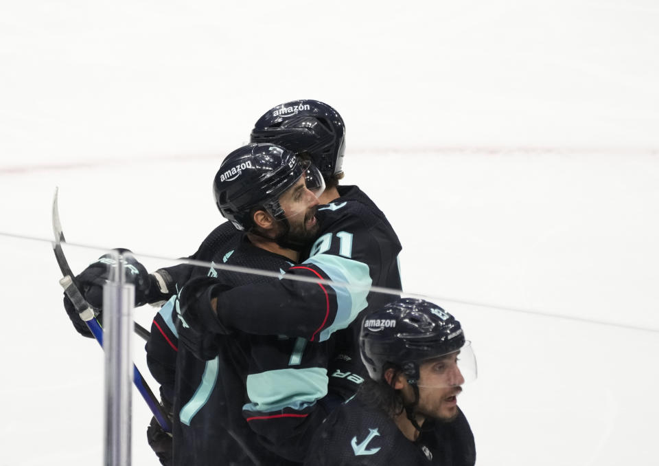 Seattle Kraken right wing Jordan Eberle, left, celebrates with teammate Daniel Sprong, right, after scoring to win the game against the Colorado Avalanche in overtime in Game 4 of an NHL hockey Stanley Cup first-round playoff series Monday, April 24, 2023, in Seattle. The Kraken won 3-2 in overtime. (AP Photo/Lindsey Wasson)