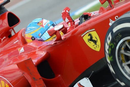 Ferrari's Spanish driver Fernando Alonso waves after winning at the Hockenheimring circuit during the German Formula One Grand Prix. Alonso extended his lead in this year's Formula One drivers' world championship on Sunday when he drove to a flawless victory for Ferrari in the German Grand Prix