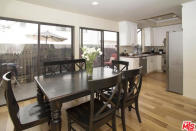 <p>The living room is connected to a dining area with large sliding doors and access to the patio. (Trulia.com) </p>