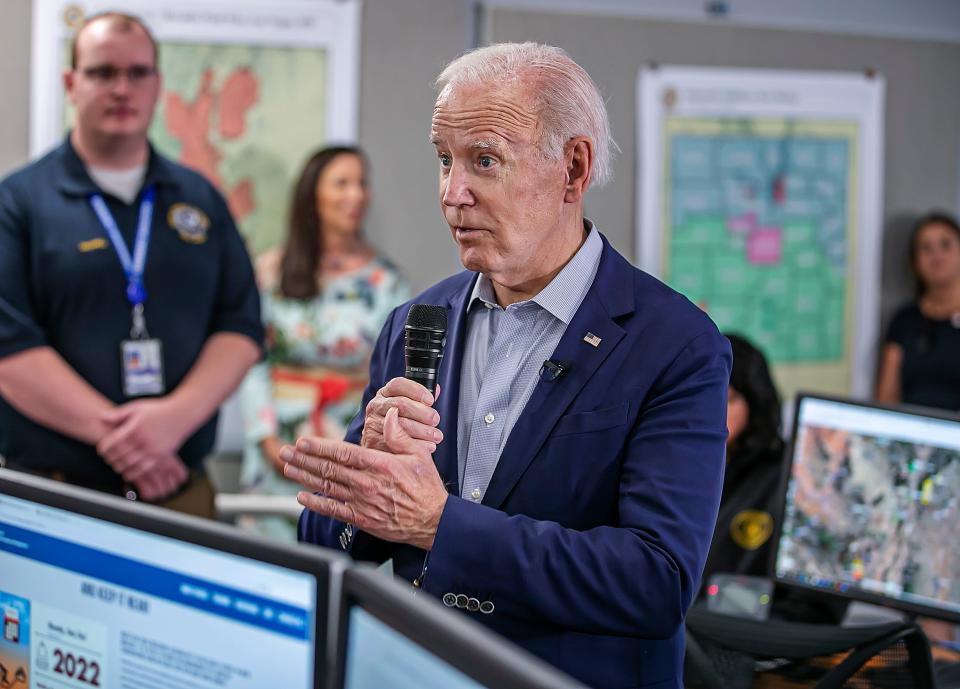 President Joe Biden talks with staff at the New Mexico State Emergency Operations Center after a fire briefing  on June 11, 2022. Biden said he would support the federal government assuming the full cost of the Hermits Peak/Calf Canyon wildfire, which has devastated a large swath of Northern New Mexico.