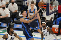 Oklahoma City Thunder center Isaiah Roby, center, shoots between Utah Jazz center Derrick Favors, left, and forward Royce O'Neale (23) in the second half of an NBA basketball game Friday, May 14, 2021, in Oklahoma City. (AP Photo/Sue Ogrocki)