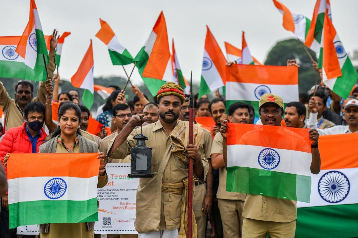 Celebrating the 75th anniversary of Indian independence in Bangalore, Aug. 8 2022. <a href="https://www.gettyimages.com/detail/news-photo/employees-of-the-postal-department-wave-the-indian-flag-as-news-photo/1242379427?adppopup=true" rel="nofollow noopener" target="_blank" data-ylk="slk:Manjunath Kiran/AFP via Getty Images;elm:context_link;itc:0;sec:content-canvas" class="link ">Manjunath Kiran/AFP via Getty Images</a>