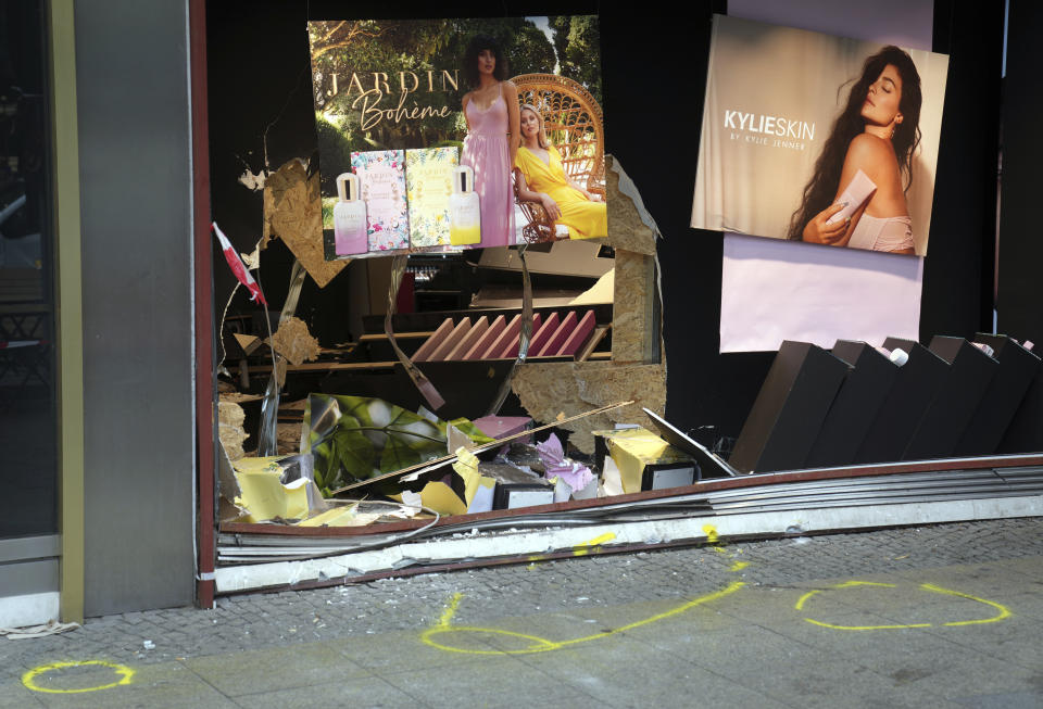 The damaged storefront at the scene of the fatal accident close to the Kaiser Wilhelm Memorial Church is pictured in Berlin, Germany, Thursday, June 9, 2022. On Wednesday June 8, a 29-year-old man drove his car into a group of students killing their teacher and crash into a store. (AP Photo/Michael Sohn)