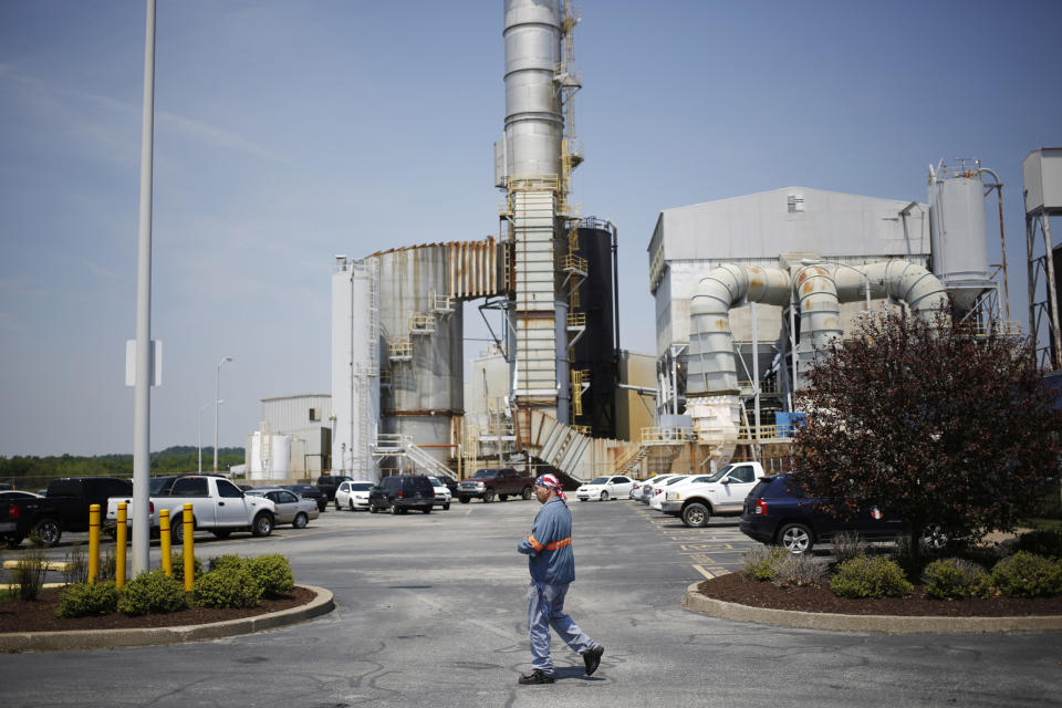 A plant employee walks through the parking lot at Century Aluminum Company's smelter (Luke Sharrett / The Washington Post via Getty Images file)
