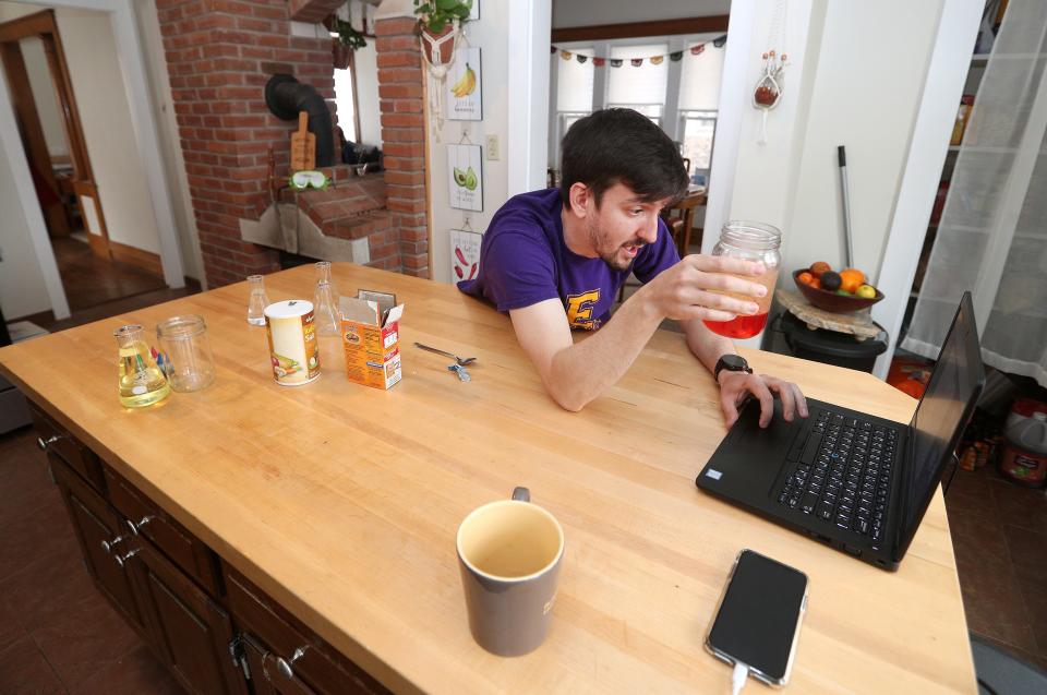 Gavin Jenkins, a science teacher at East High School, does an experiment from his kitchen and broadcasts online to his students on March 27, 2020.  Jenkins tries to help his students keep engaged and caught up on lessons while the coronavirus keeps schools closed.