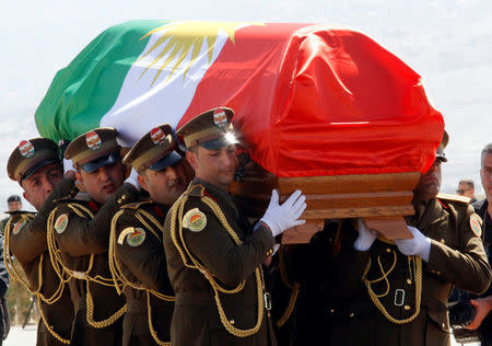 The coffin of former Iraqi president Jalal Talabani is covered with a Kurdish flag at Sulaimaniya Airport, Iraq October 6, 2017. REUTERS/Ako Rasheed