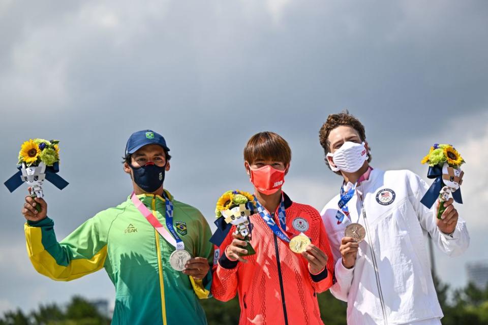 Gold medallist Japan's Yuto Horigome (C), silver medallist Brazil's Kelvin Hoefler (L) and bronze medallist Jagger Eaton of the US pose on the podium at the end of the men's street prelims during the Tokyo 2020 Olympic Games at Ariake Sports Park Skateboarding in Tokyo on July 25, 2021.<span class="copyright">Jeff Pachoud–AFP/Getty Images</span>