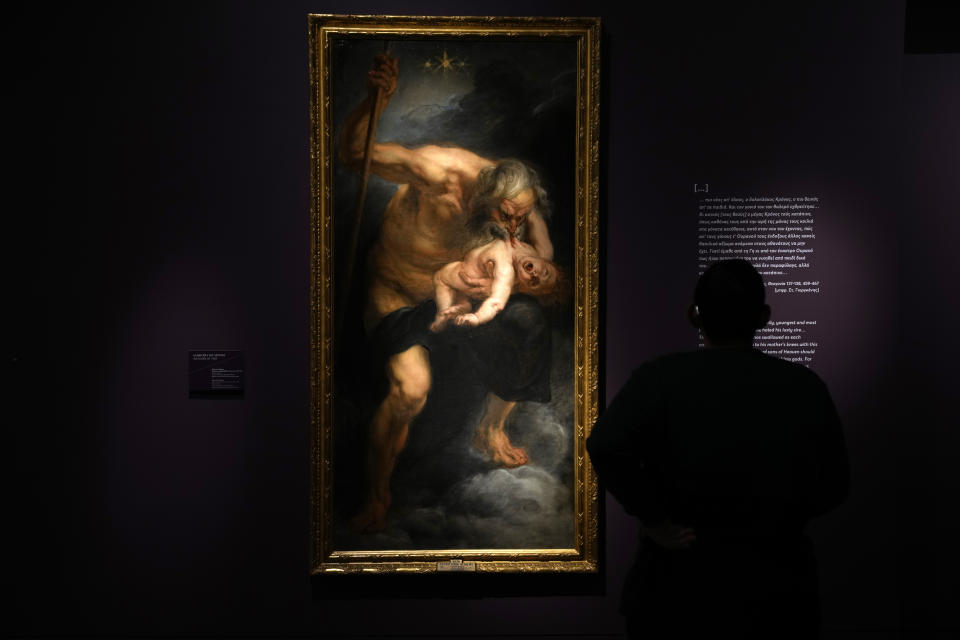 A man observes the painting, Saturn (Kronos) devouring his son, 1636-1638, by Peter Paul Rubens ahead of the Greece's Acropolis Museum official launch of an exhibition, in Athens, Tuesday, Dec. 5, 2023. The artifact will be displayed as part of an exhibition "Meanings: Personifications and Allegories, from Antiquity to Today" that will include 165 works of art, many from leading European museums and many being loaned for the first time. (AP Photo/Thanassis Stavrakis)