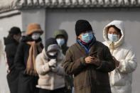 Residents stand in line for their routine COVID-19 tests in the freezing cold weather in Beijing, Tuesday, Nov. 29, 2022. Chinese universities are sending students home as the ruling Communist Party tightens anti-virus controls and tries to prevent more protests after crowds angered by its severe "zero COVID" restrictions called for President Xi Jinping to resign in the biggest show of public dissent in decades. (AP Photo/Andy Wong)