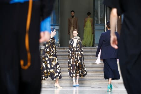 Models present creations during the Victoria Beckham catwalk show at London Fashion Week in London