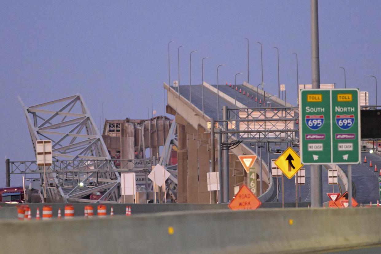 Parts of the Francis Scott Key Bridge remain after a container ship collided with a support, causing the center span to collapse, on Tuesday, March 26, 2024 in Baltimore.  / Credit: Steve Ruark / AP