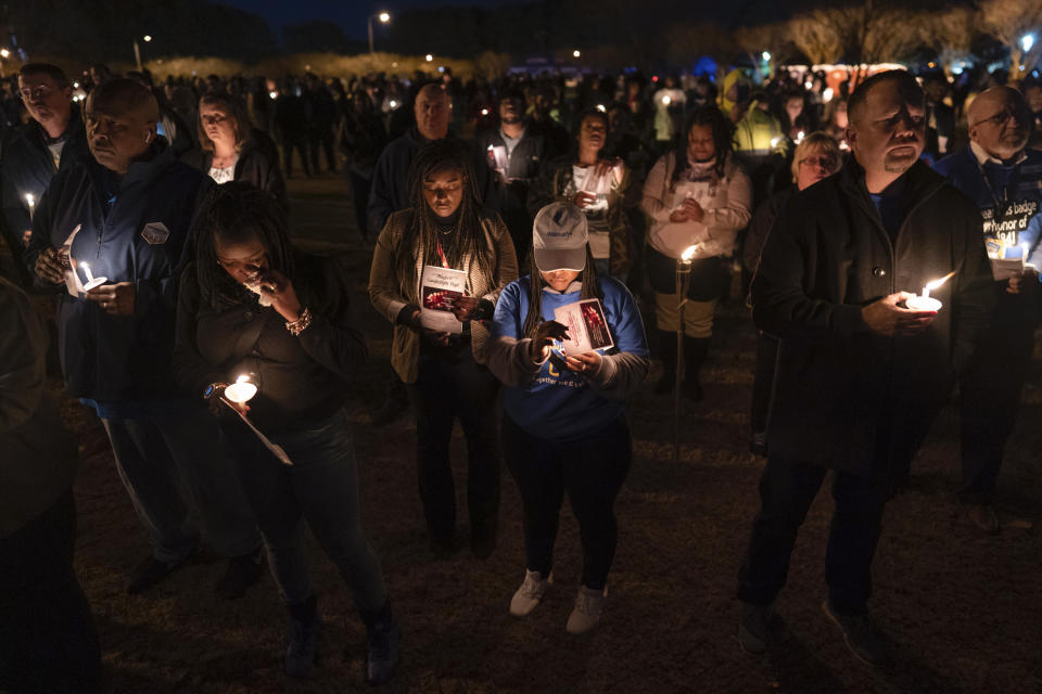 Community members, including Walmart employees, gather for a candlelight vigil at Chesapeake City Park in Chesapeake, Va., Monday, Nov. 28, 2022, for the six people killed at a Walmart in Chesapeake, Va., when a manager opened fire with a handgun before an employee meeting last week. (AP Photo/Carolyn Kaster)