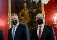 New Chancellor of the People's Party Karl Nehammer, left, and his predecessor Alexander Schallenberg arrive for the swearing-in ceremony at Hofburg Palace in Vienna, Austria, Monday, Dec. 6, 2021. (AP Photo/Lisa Leutner)