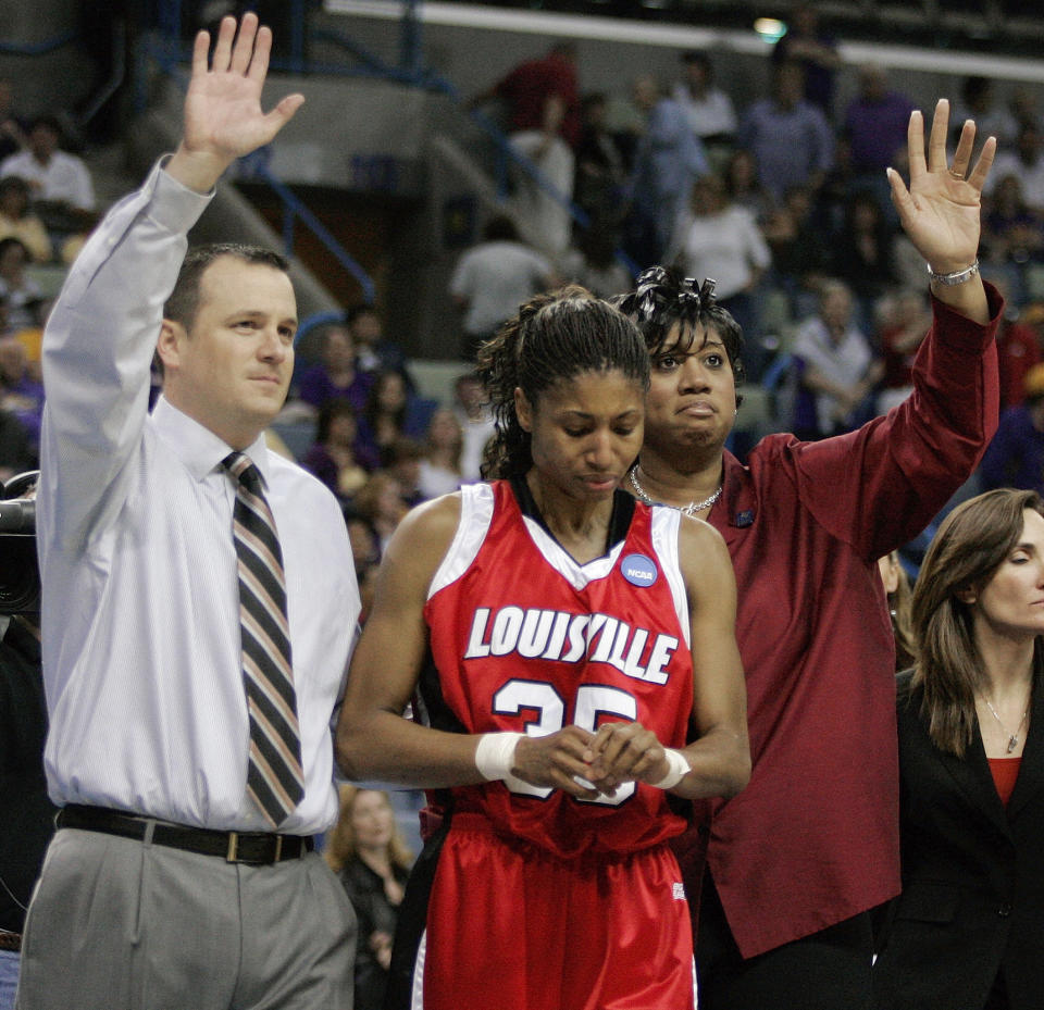 FILE - Louisville coach Jeff Walz and assistant coach Michelle Clark-Heard wave goodbye to fans as Angel McCoughtry looks down after North Carolina defeated Louisville 78-74 in a semifinal of the New Orleans regional of the women's NCAA basketball tournament in New Orleans, Saturday, March 29, 2008. During a career that spans more than a decade, McCoughtry, a former No. 1 overall pick by the WNBA’s Atlanta Dream, got used to being around people who didn’t look like or understand her. (AP Photo/Donna McWilliam, File)