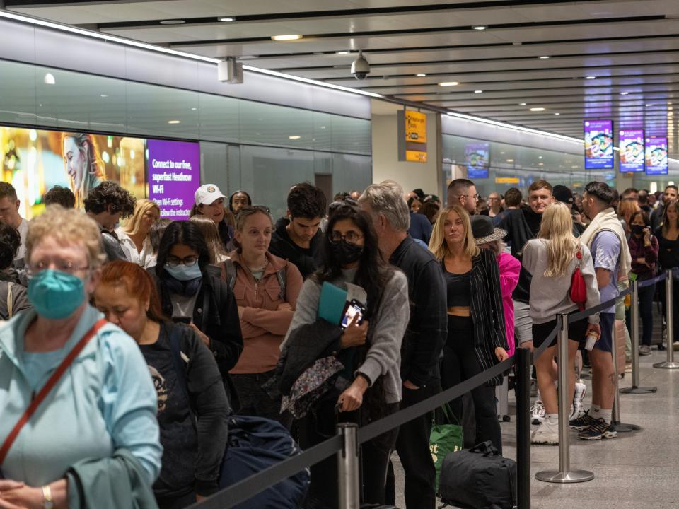 People wait in long queues for security at Heathrow Airport on June 1.