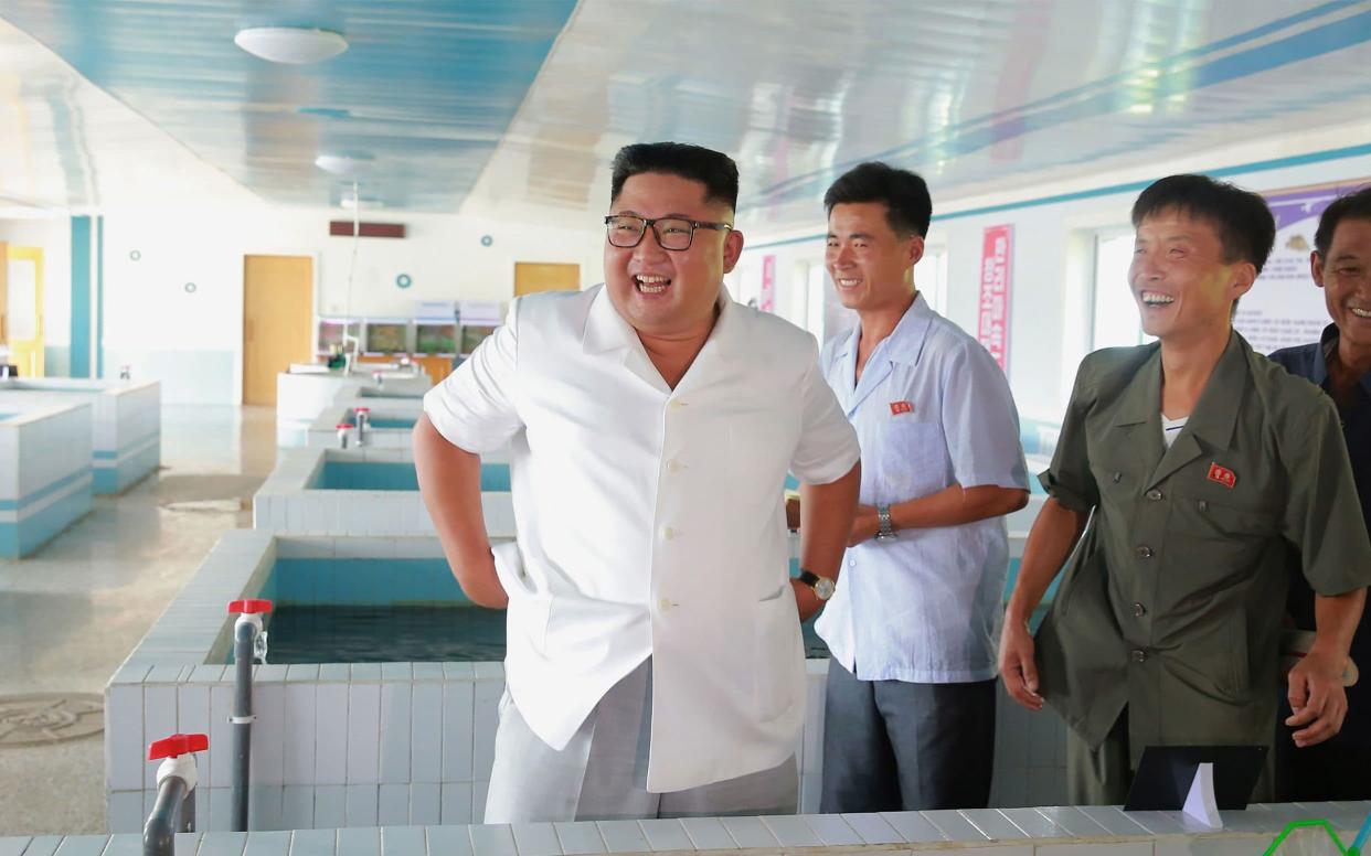 North Korea released pictures of Kim Jong-un at a fish stocking station in what analyst believe is the latest attempt to shift the focus to the economy - AFP