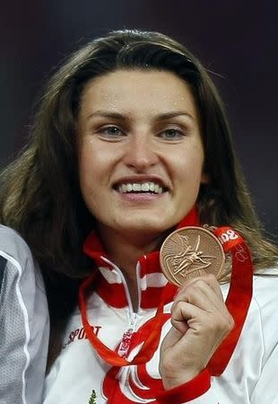 Women's high jump bronze medallist Anna Chicherova of Russia poses on podium during the medals ceremony of the athletics competition in the National Stadium at the Beijing 2008 Olympic Games August 23, 2008. REUTERS/Mike Blake