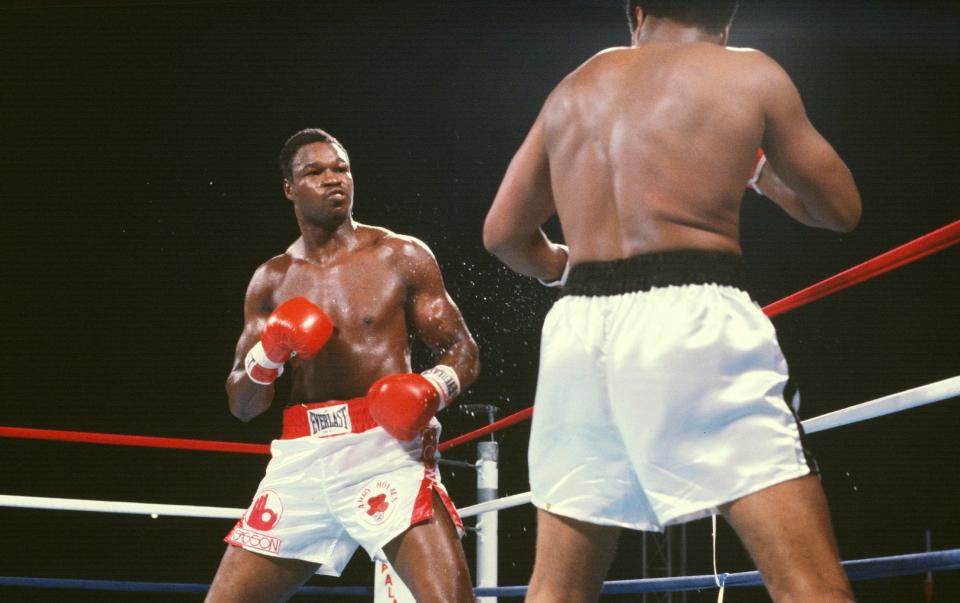 Holmes beats his idol and mentor Muhammad Ali - Focus on Sport/Getty Images