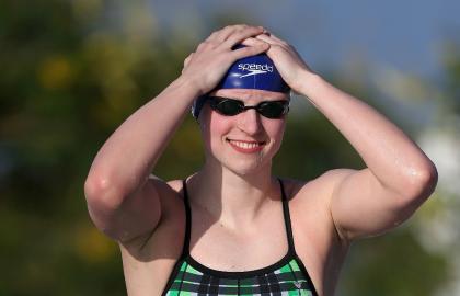 Katie Ledecky adjusts her cap before competing in a final at the Arena Pro Swim Series on April 17. (AFP)