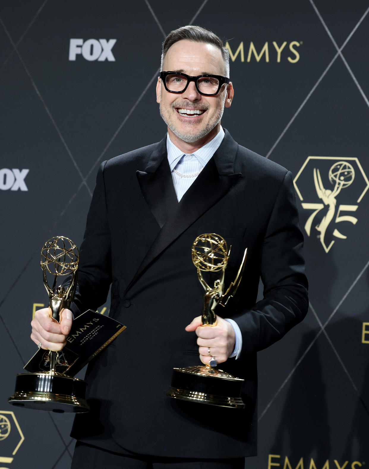 John's husband, David Furnish, holds both his and John's Emmys after he won for producing the variety special.