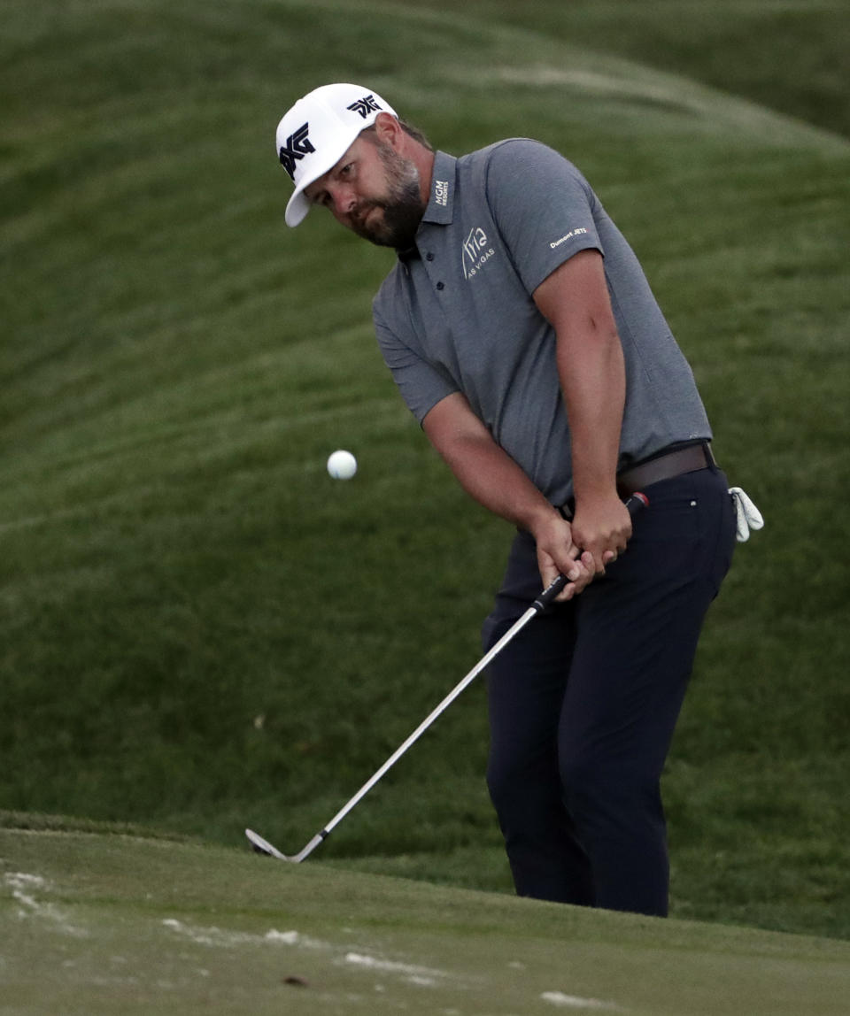 Ryan Moore chips onto the ninth green during the first round of The Players Championship golf tournament Thursday, March 14, 2019, in Ponte Vedra Beach, Fla. (AP Photo/Lynne Sladky)