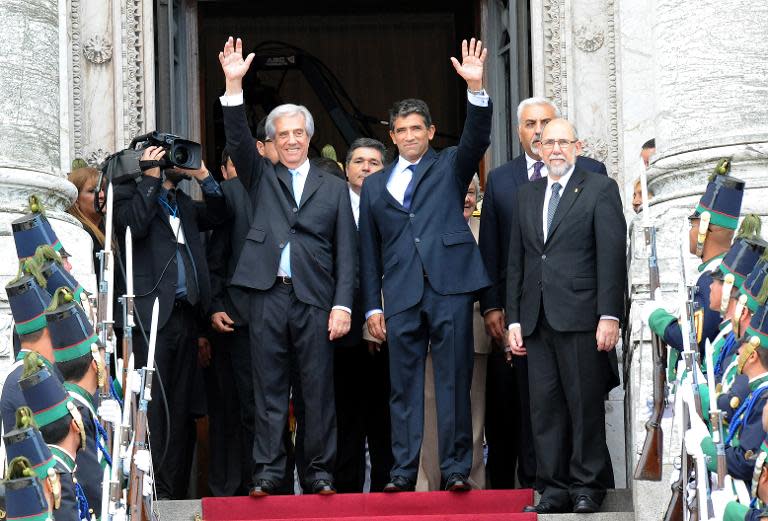 Uruguayan President Tabare Vazquez (left) and his Vice-President Raul Sendic wave to supporters outside the Congress building in Montevideo, on March 1, 2015