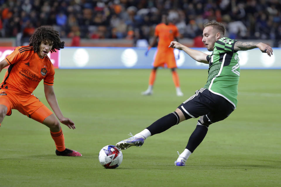 Austin FC defender Zan Kolmanic, right, moves the ball against Houston Dynamo forward Ivan Franco during the second half of an MLS soccer match Saturday, March 18, 2023, in Houston. (AP Photo/Michael Wyke)