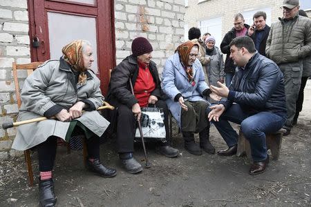 Ukrainian Prime Minister Volodymyr Groysman meets with local residents at a collection point for evacuees after ammunition detonated at a military base in the town of Balaklia (Balakleya), Kharkiv region, Ukraine, March 23, 2017. REUTERS/Vladyslav Musiienko/Pool