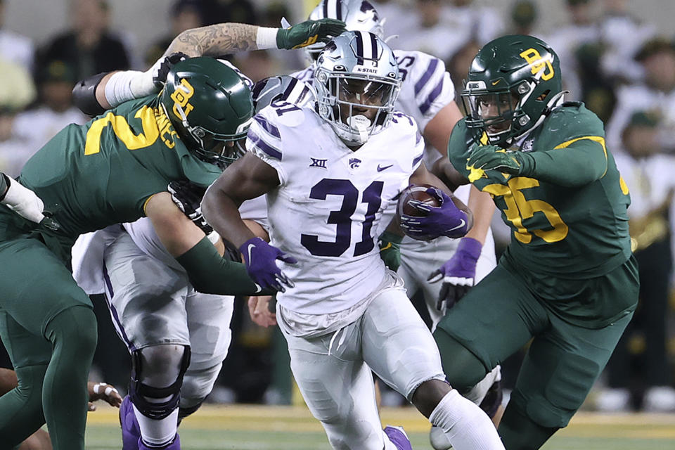 FILE - Kansas State running back DJ Giddens (31) runs between Baylor linebackers Matt Jones (2) and Jackie Marshall (35) in the second half of an NCAA college football game, Saturday, Nov. 12, 2022, in Waco, Texas. Kansas State opens their season at home against Southeast Missouri State on Sept. 2. (AP Photo/Jerry Larson, File)