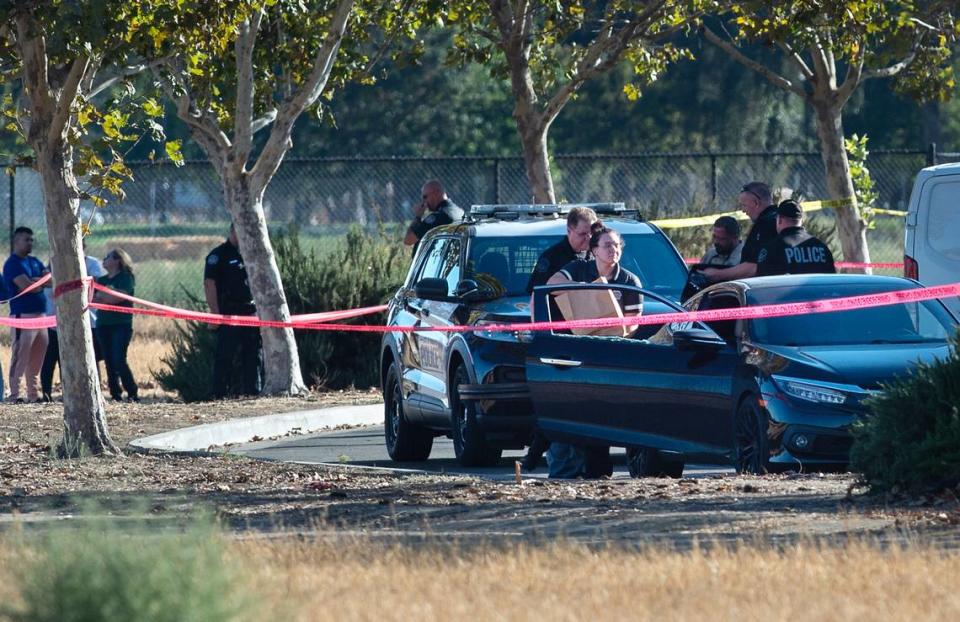 Modesto Police investigate the discovery of a body in a car in the parking lot of St. Stanislaus Catholic Church on Maze Boulevard in Modesto, Calif., on Saturday, September 24, 2022.