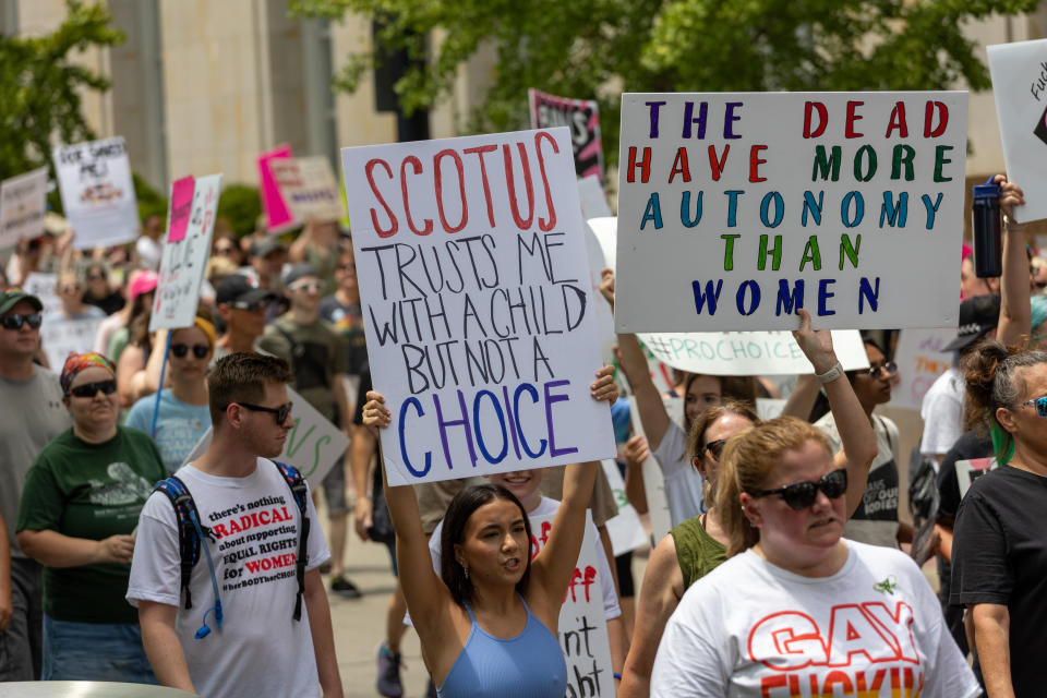 Abortion rights advocates gather and march outside.