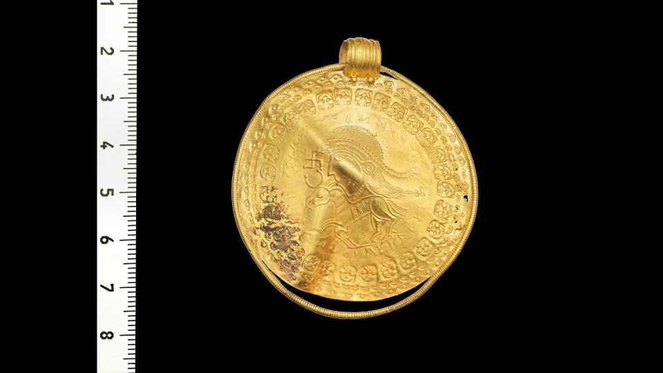 The bracteate – a pendant stamped on a thin piece of gold – features an inscription in runic letters that reads 