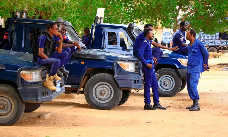 Sudanese security forces outside the court in Khartoum before the trial of Omar al-Bashir