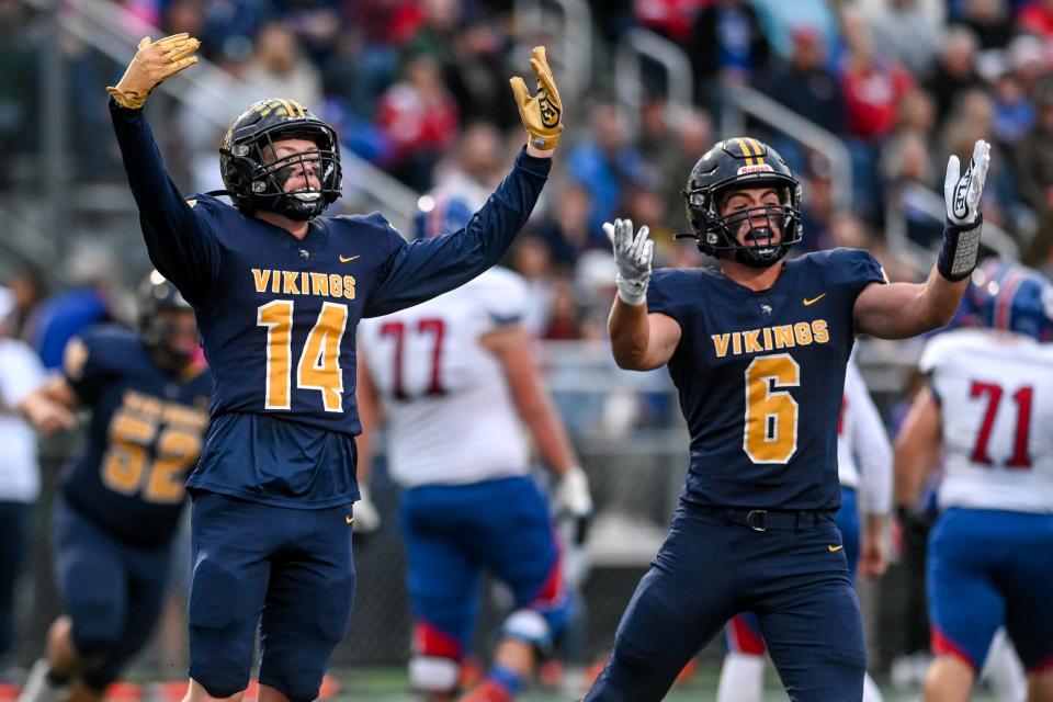 Haslett's Brayden Stellard, left, and Conner Bailey celebrate a stop for a loss against Mason during the first quarter on Friday, Sept. 23, 2022, at Haslett High School.