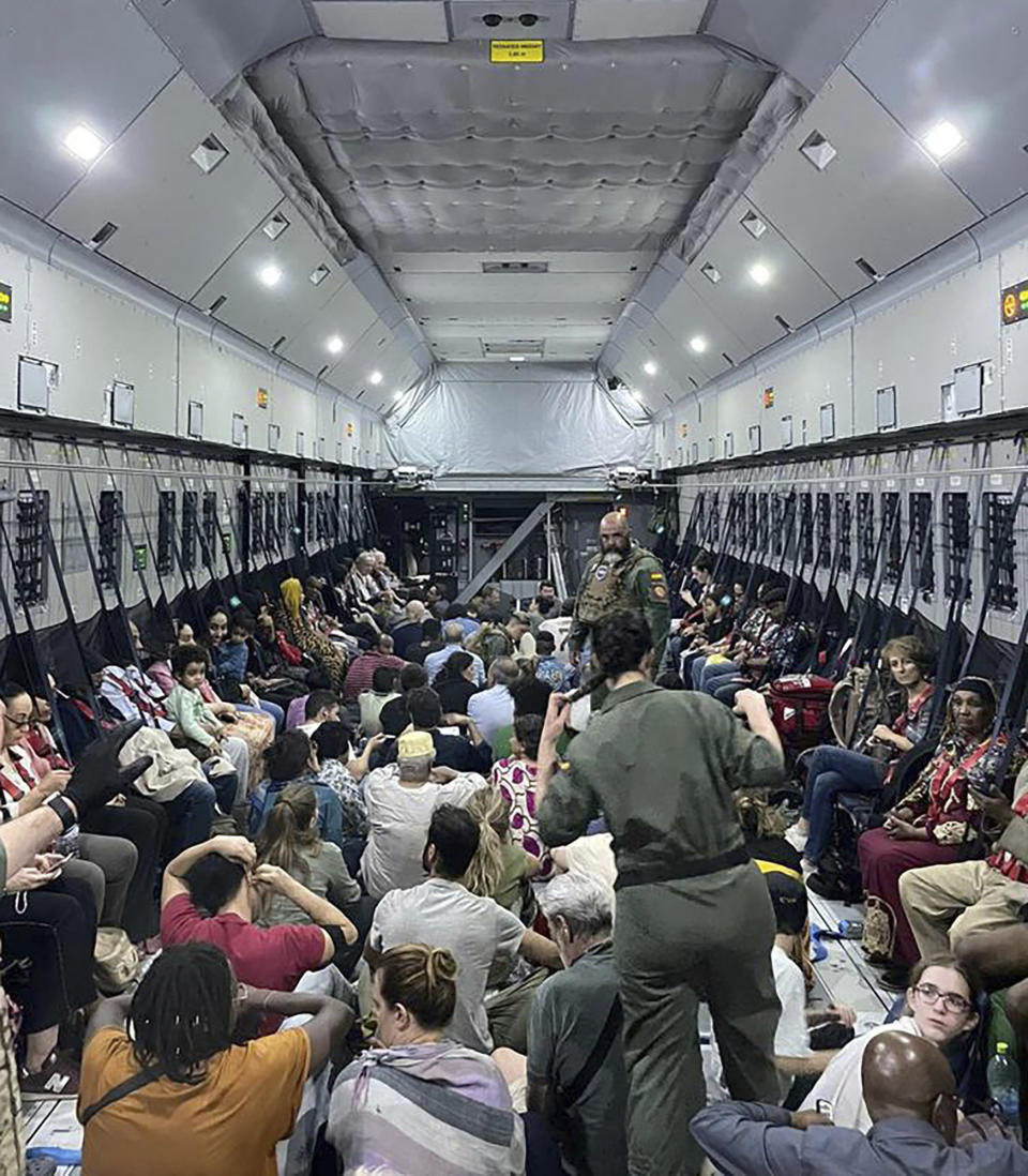 In this photo provided by the Spanish Defence Ministry, citizens of different nationalities fleeing from Sudan sit inside a Spanish Air Force aircraft on its way to Madrid on Monday April 24, 2023. (Spanish Defence Ministry via AP)